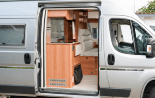 A van with the door open and the interior of it.