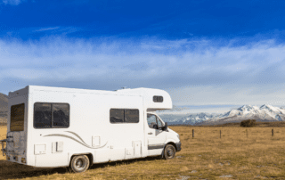 A white rv parked in the middle of nowhere.